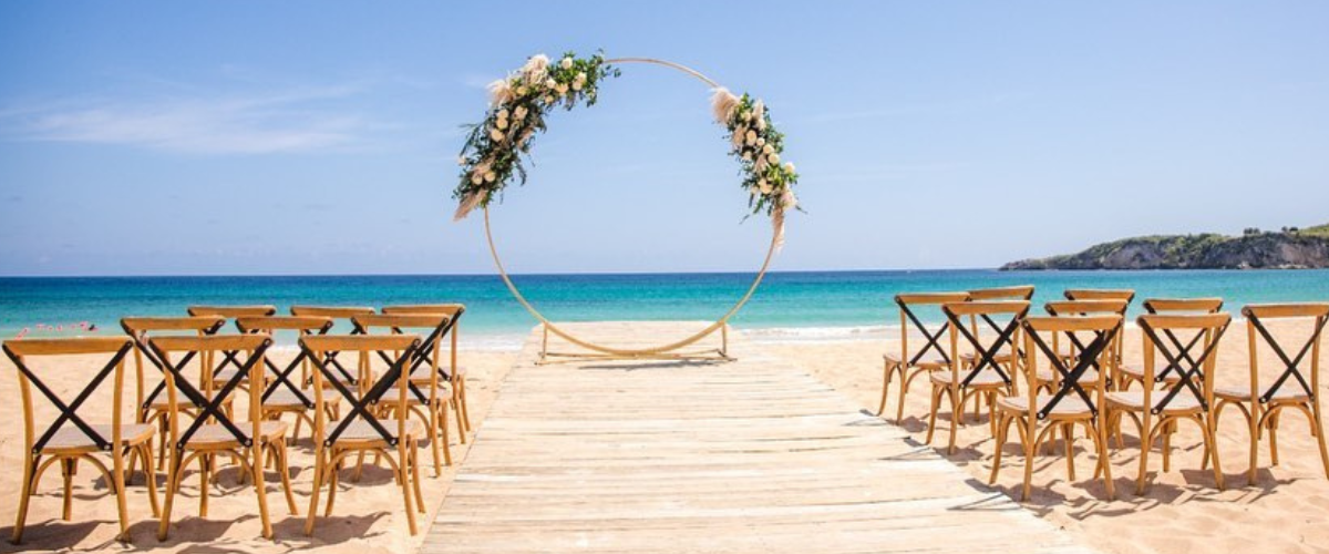 Destination wedding, outdoor beach wedding ceremony setting, circle arch with flowers draping