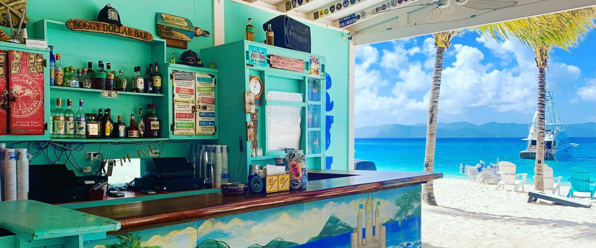 Soggy Bottom Dollar Bar in the British Virgin Islands set right in the sand near the water