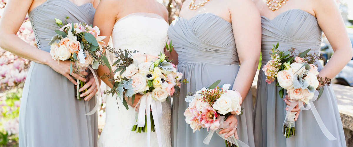 Close up of bride and bridesmaids dresses and flowers before the ceremony 