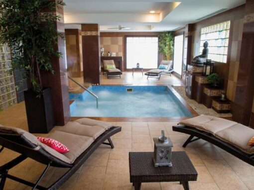 jacuzzi at the spa at the Riu Hotel in Aruba. Lounge chairs set up in front of the pool.