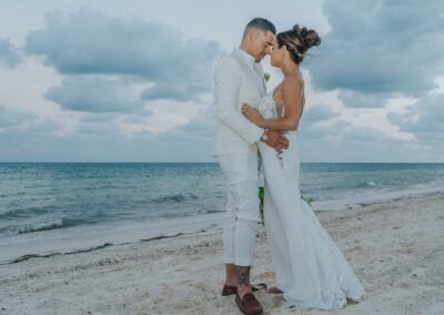 couple on the beach on their wedding day. Caribbean tropical beach and clouds in the late afternoon.