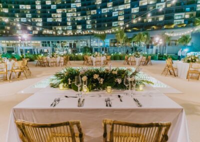 hotel set up outside at resort for destination wedding. Candles, wine glasses, and flowers set up at the table.